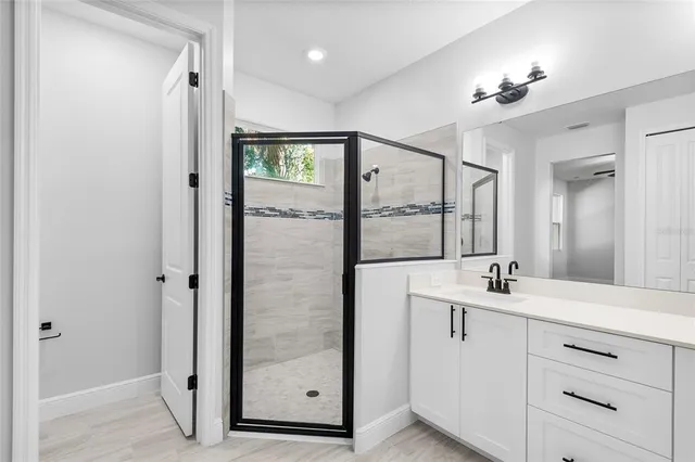 a bathroom with a double vanity sink mirror and shower