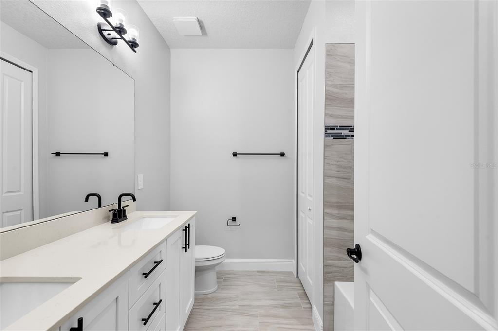 371 Miller Road Sanford, FL 32773 - Photo 27 of 50 a bathroom with a sink a toilet and shower