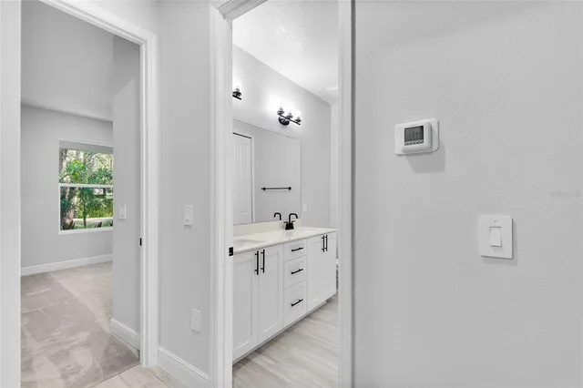 a bathroom with a double vanity sink and mirror with shower