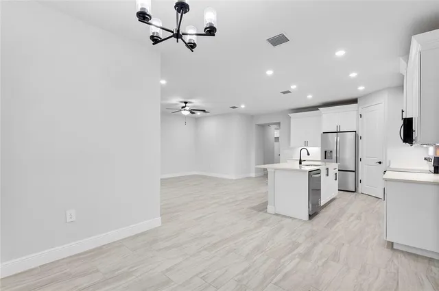 a view of a kitchen with a sink and wooden floor