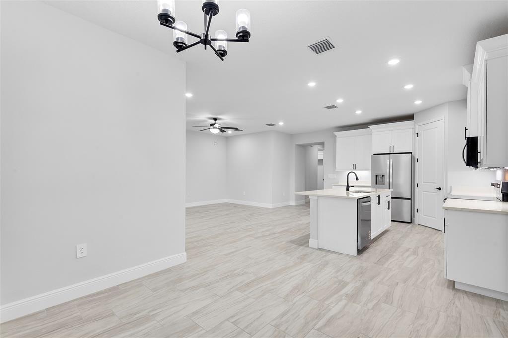 371 Miller Road Sanford, FL 32773 - Photo 3 of 50 a view of a kitchen with a sink and wooden floor