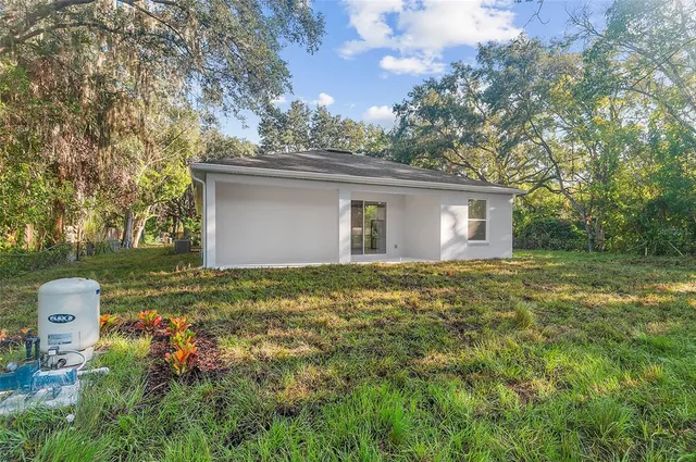 a backyard of a house with table and chairs