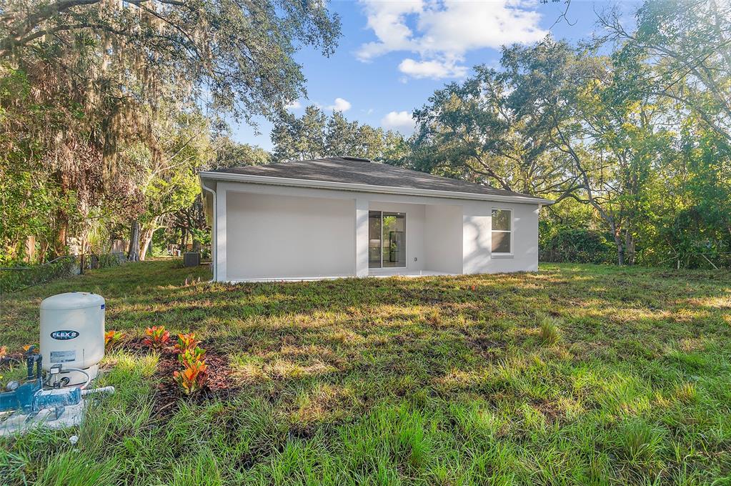 371 Miller Road Sanford, FL 32773 - Photo 41 of 50 a backyard of a house with table and chairs