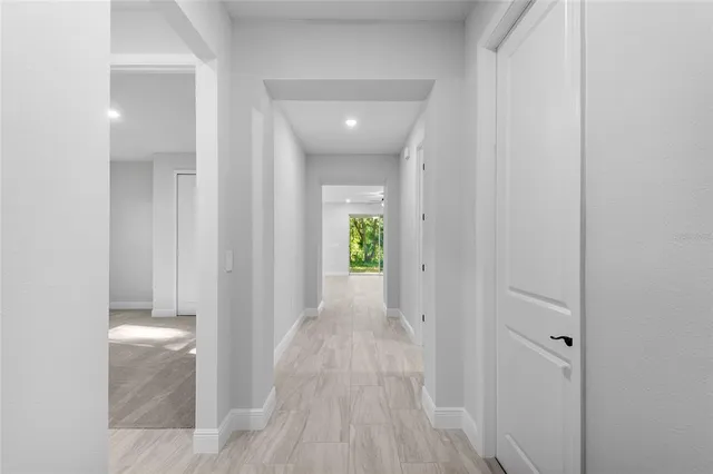 a view of a hallway with wooden floor