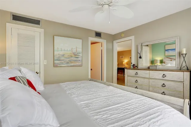 a bedroom with a bed and a mirror on dresser