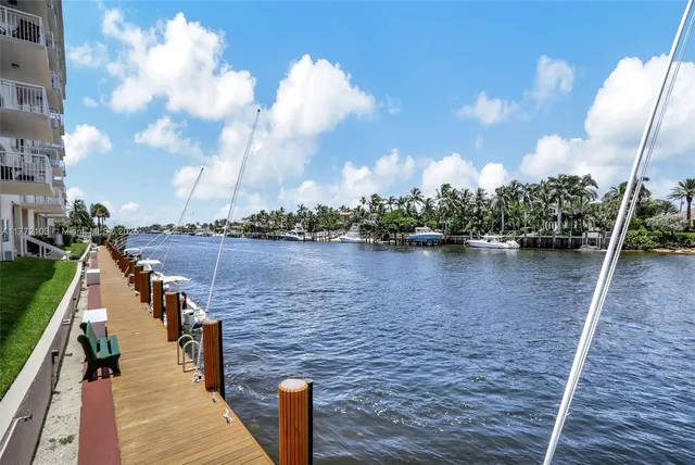 a view of a lake with boats and wooden stairs