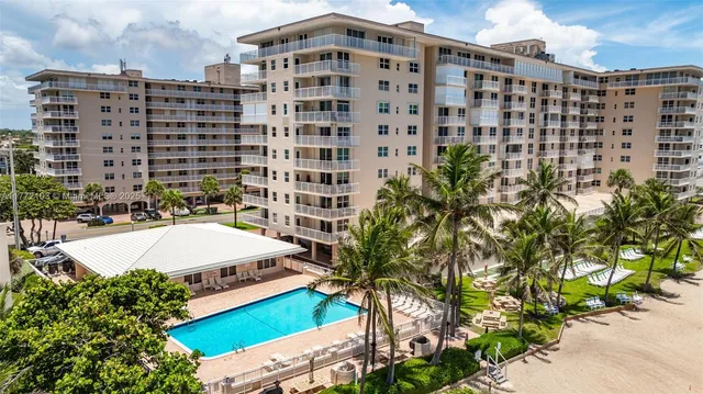 a picture of building with a yard and plants