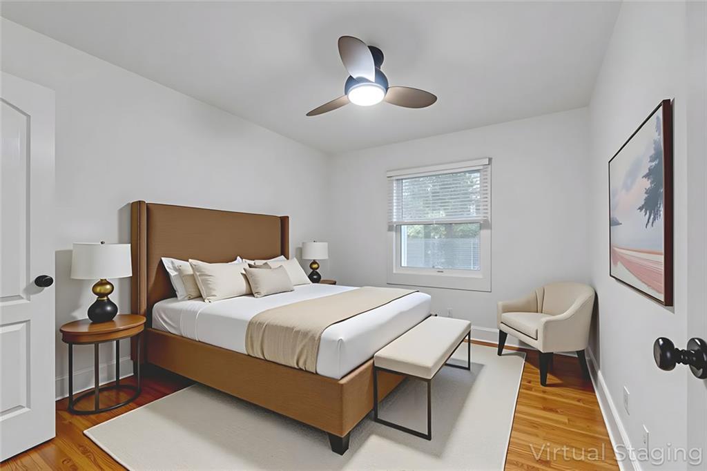 351 Cherokee Avenue Southeast, Unit 6 Atlanta, GA 30312 - Photo 4 of 11 a bedroom with a bed and a chandelier