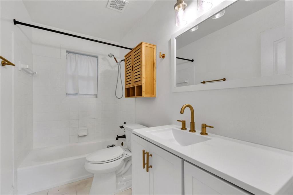 351 Cherokee Avenue Southeast, Unit 6 Atlanta, GA 30312 - Photo 5 of 11 a bathroom with a sink a toilet and shower