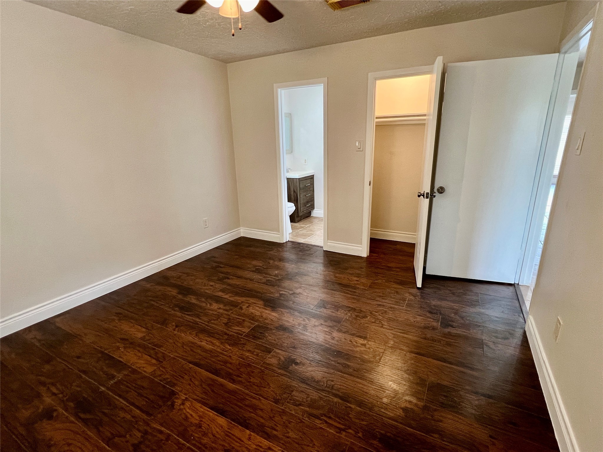12110 Murr Way Houston, TX 77048 - Photo 19 of 24 an empty room with wooden floor and chandelier fan