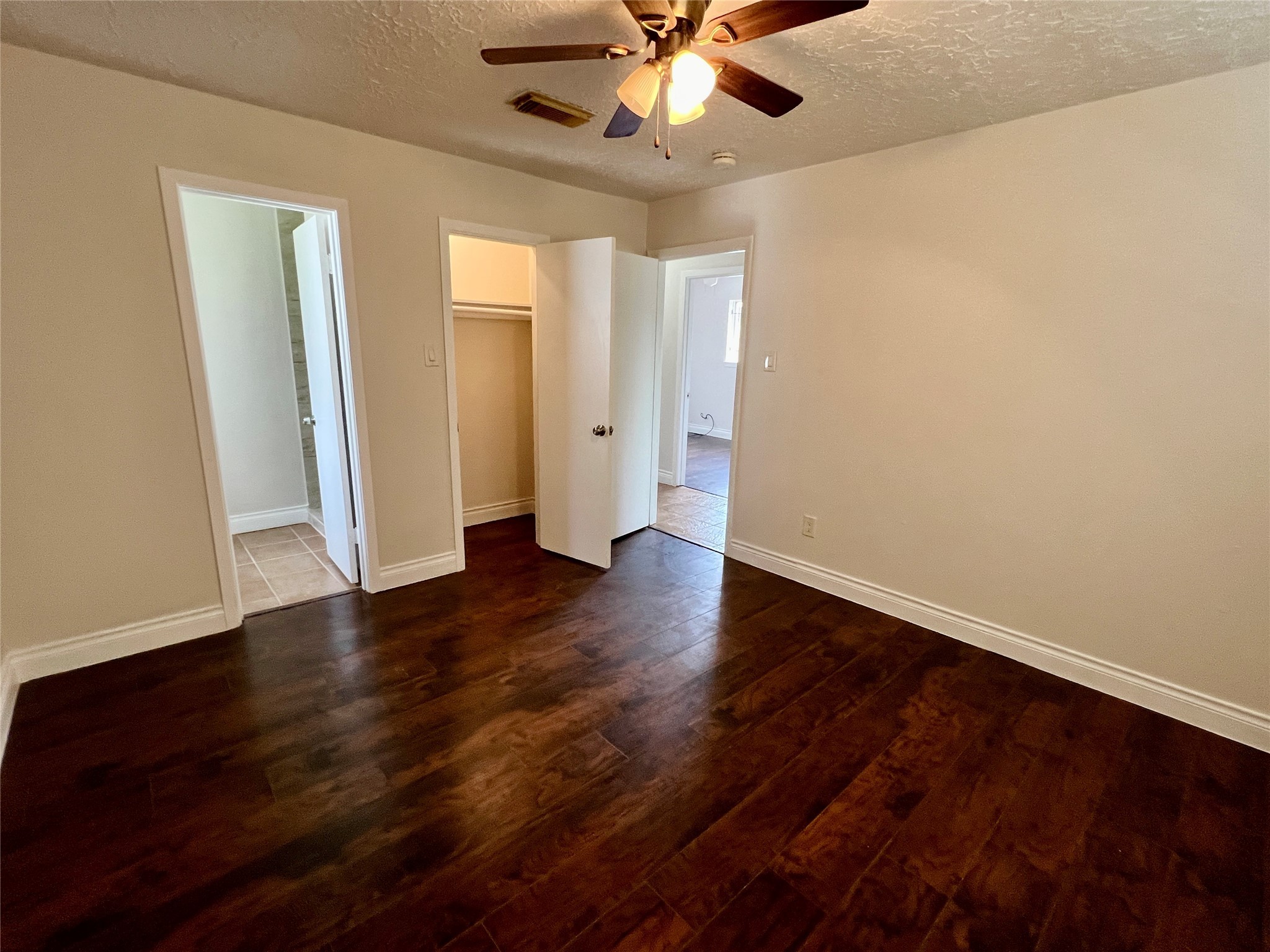 12110 Murr Way Houston, TX 77048 - Photo 20 of 24 a view of an empty room with wooden floor and a ceiling fan