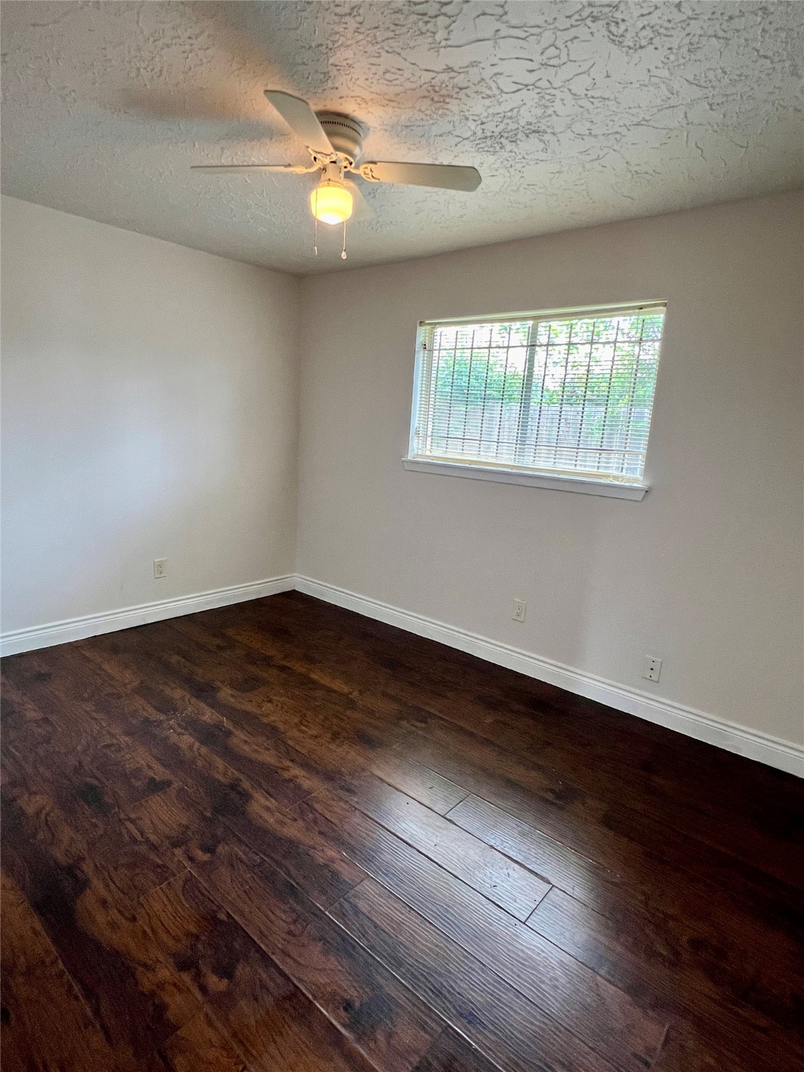 12110 Murr Way Houston, TX 77048 - Photo 22 of 24 an empty room with wooden floor and windows