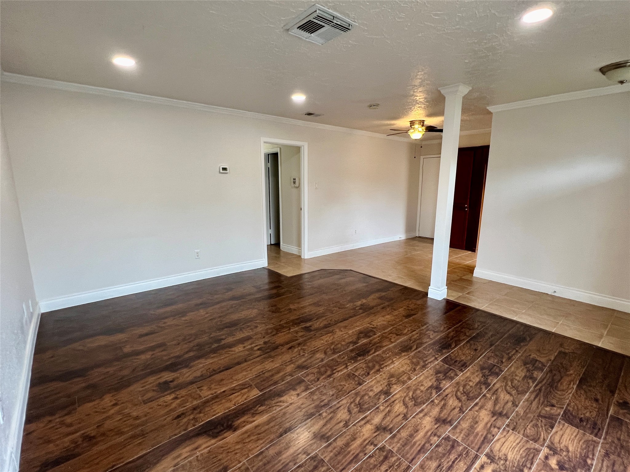 12110 Murr Way Houston, TX 77048 - Photo 5 of 24 an empty room with wooden floor and a ceiling fan