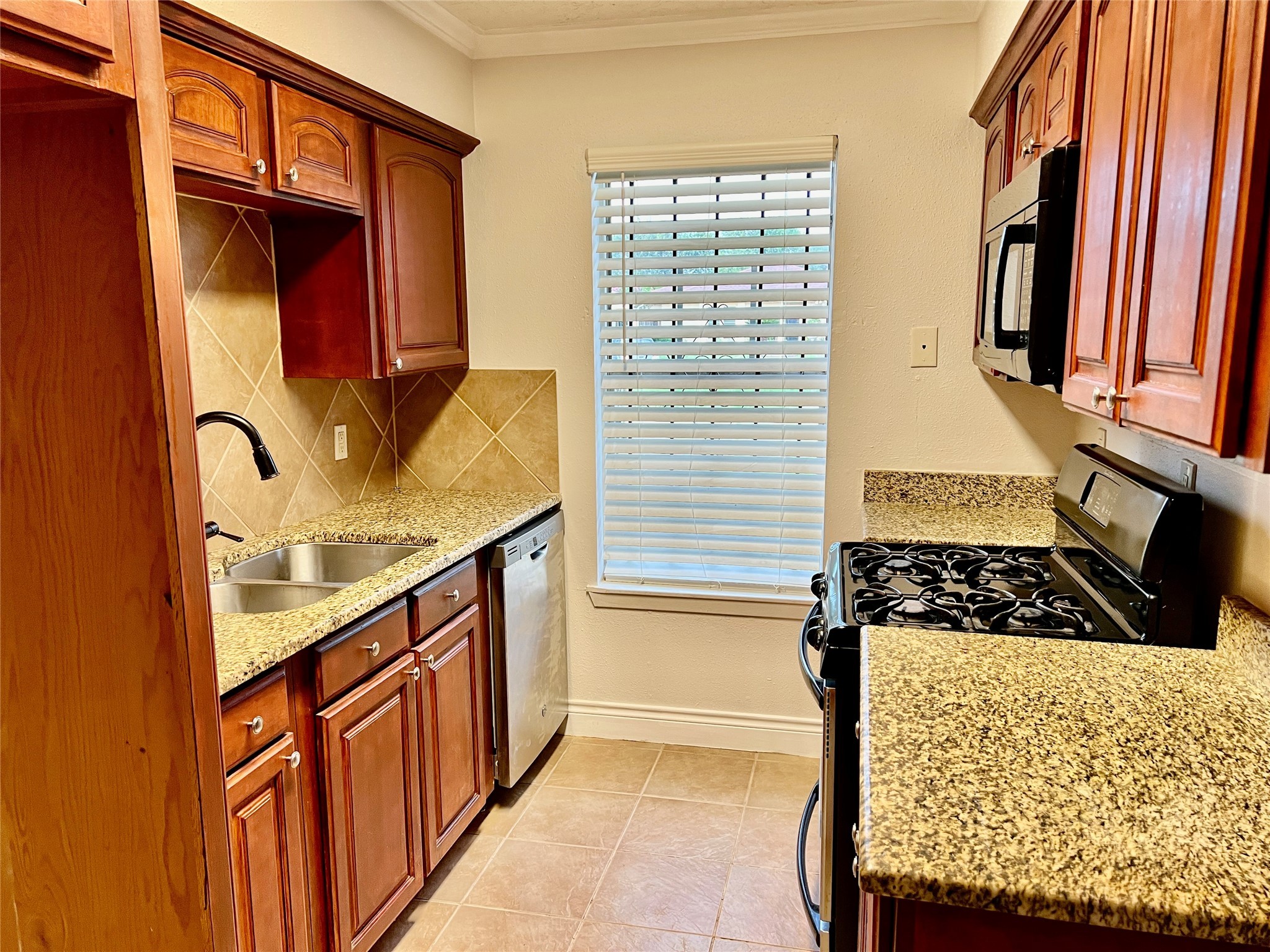 12110 Murr Way Houston, TX 77048 - Photo 8 of 24 a bathroom with a granite countertop sink and a washing machine