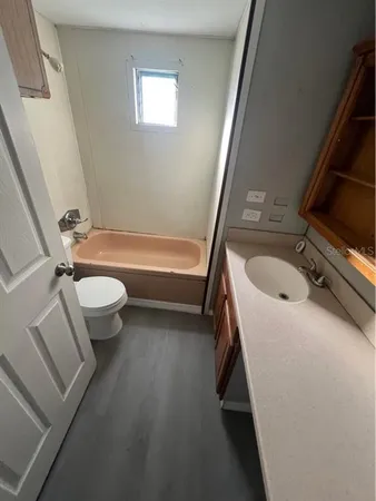 a bathroom with a sink a toilet and a bathtub
