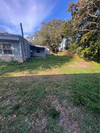 a view of a backyard with large trees