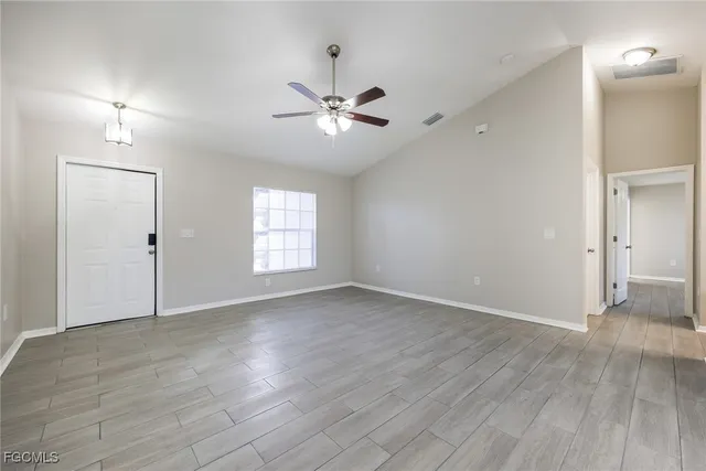wooden floor in an empty room with a window