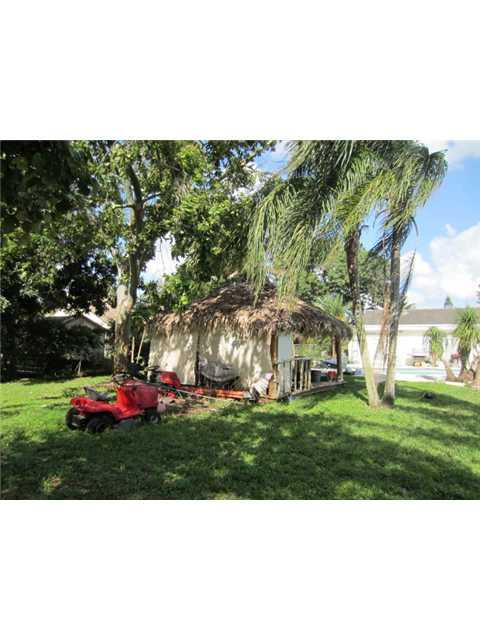 5675 Southwest 111th Terrace Davie, FL 33328 - Photo 11 of 16 a view of a garden with an trees