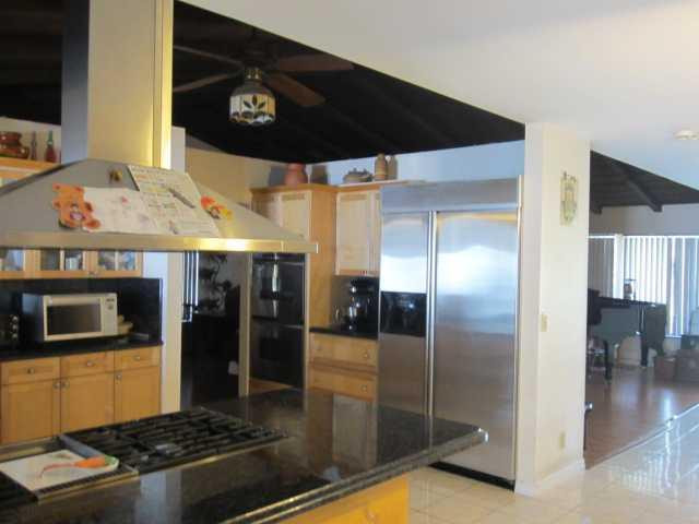 5675 Southwest 111th Terrace Davie, FL 33328 - Photo 2 of 16 a kitchen with stainless steel appliances granite countertop a refrigerator and a stove top oven