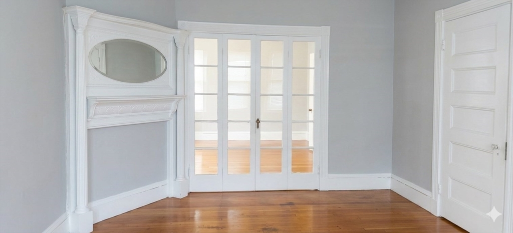 9 Oakview Terrace, Unit 2 Boston, MA 02130 - Photo 3 of 8 a view of an empty room with a window and wooden floor
