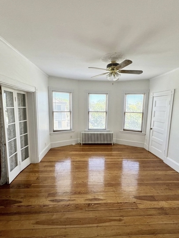 9 Oakview Terrace, Unit 2 Boston, MA 02130 - Photo 4 of 8 an empty room with wooden floor and windows