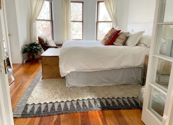 a bedroom with a bed and window