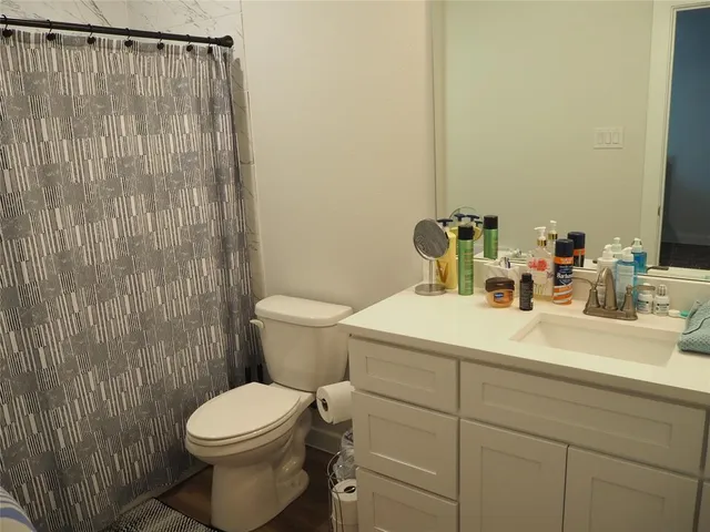 a bathroom with a sink a toilet and a mirror