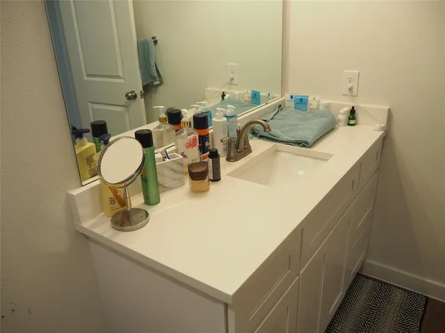 a bathroom with a sink and mirror