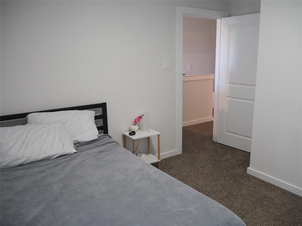 1220 Elva Warren Street Fort Worth, TX 76115 - Photo 16 of 23 a bedroom with a bed and a window