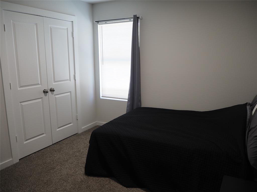 1220 Elva Warren Street Fort Worth, TX 76115 - Photo 17 of 23 a bedroom with a bed and a window