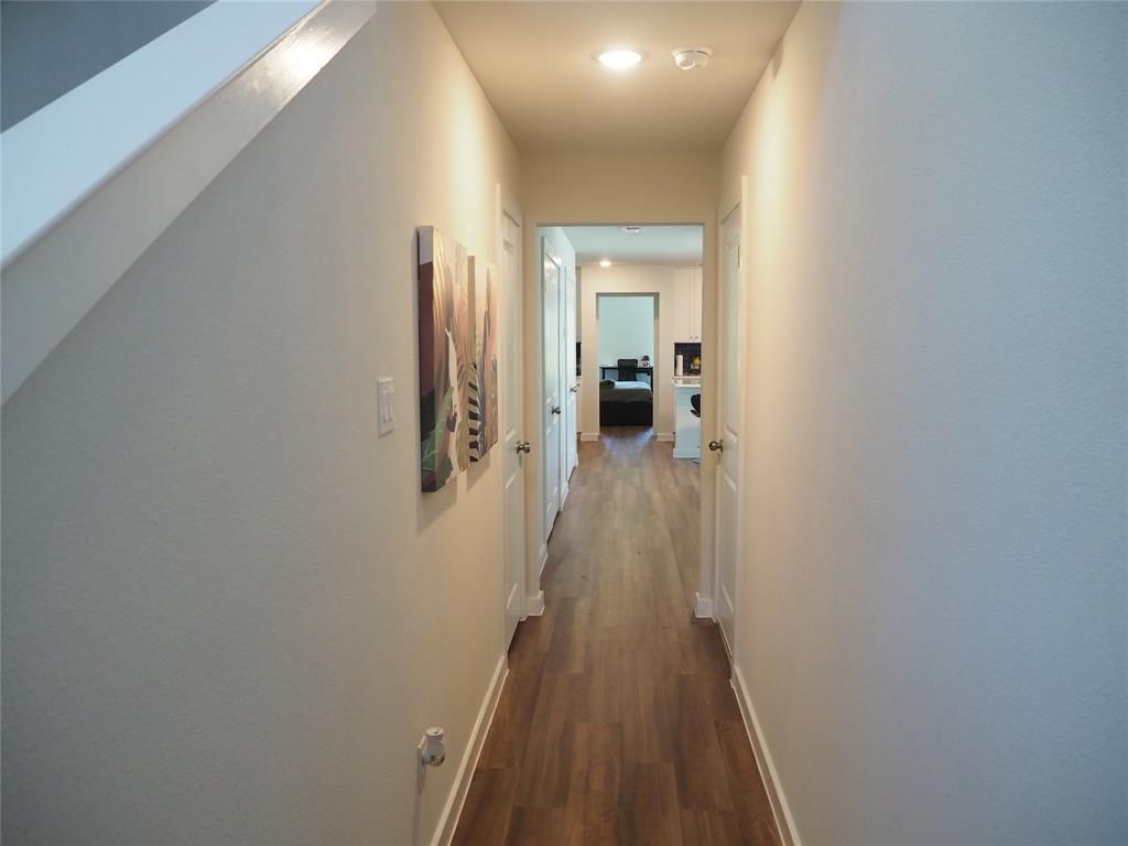 1220 Elva Warren Street Fort Worth, TX 76115 - Photo 5 of 23 a view of a hallway with wooden floor