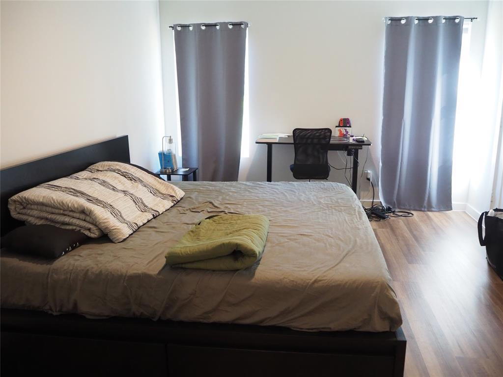 1220 Elva Warren Street Fort Worth, TX 76115 - Photo 9 of 23 a bedroom with a bed and wooden floor