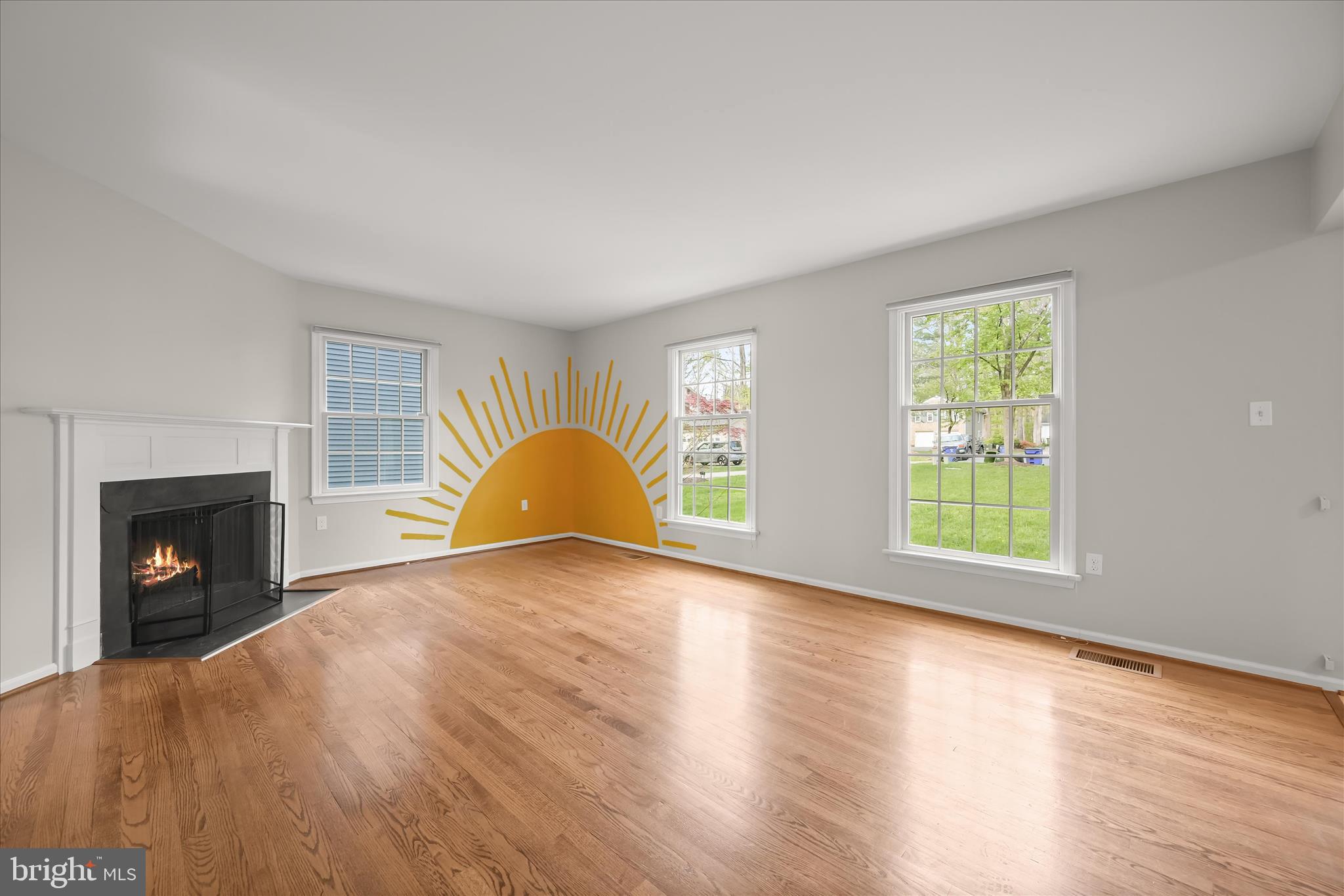 10428 Schoolmaster Place Columbia, MD 21044 - Photo 11 of 69 an empty room with wooden floor fireplace and windows