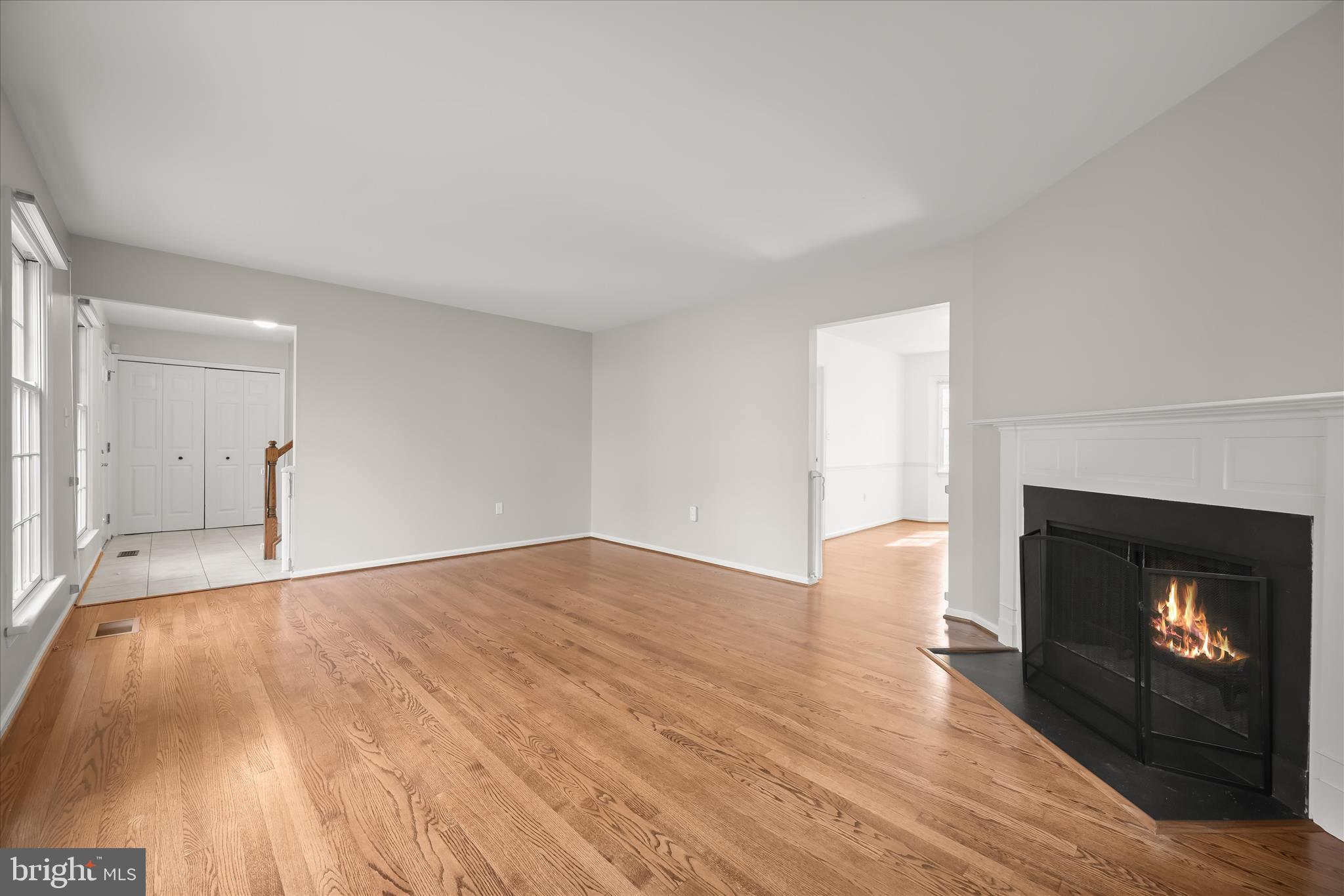 10428 Schoolmaster Place Columbia, MD 21044 - Photo 12 of 69 a view of an empty room with wooden floor fireplace and a window