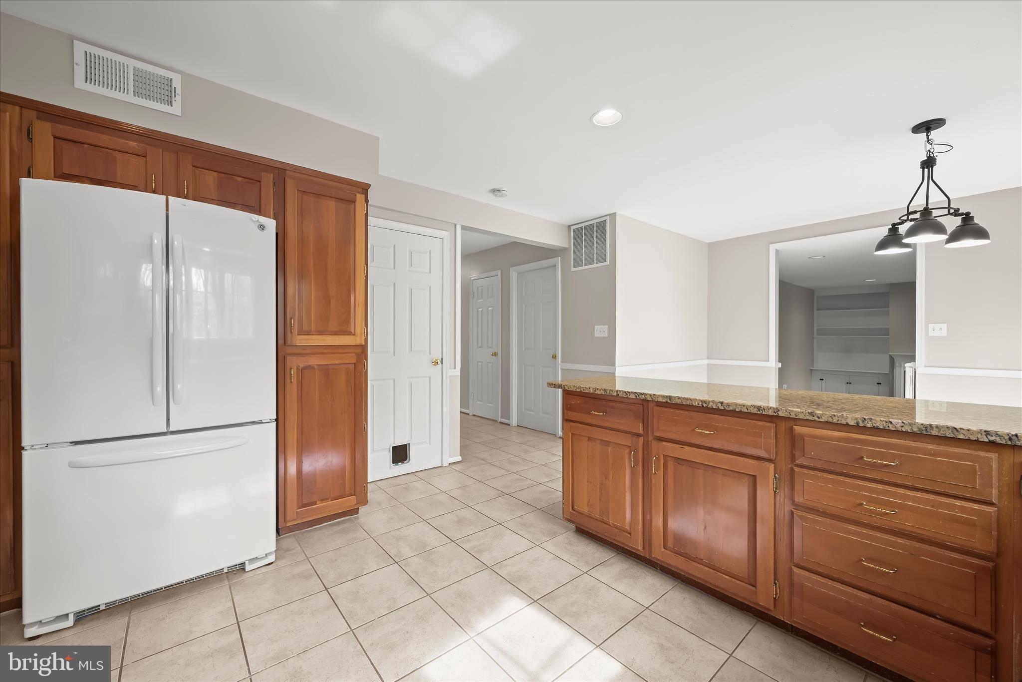 10428 Schoolmaster Place Columbia, MD 21044 - Photo 21 of 69 a large kitchen with a refrigerator and a sink