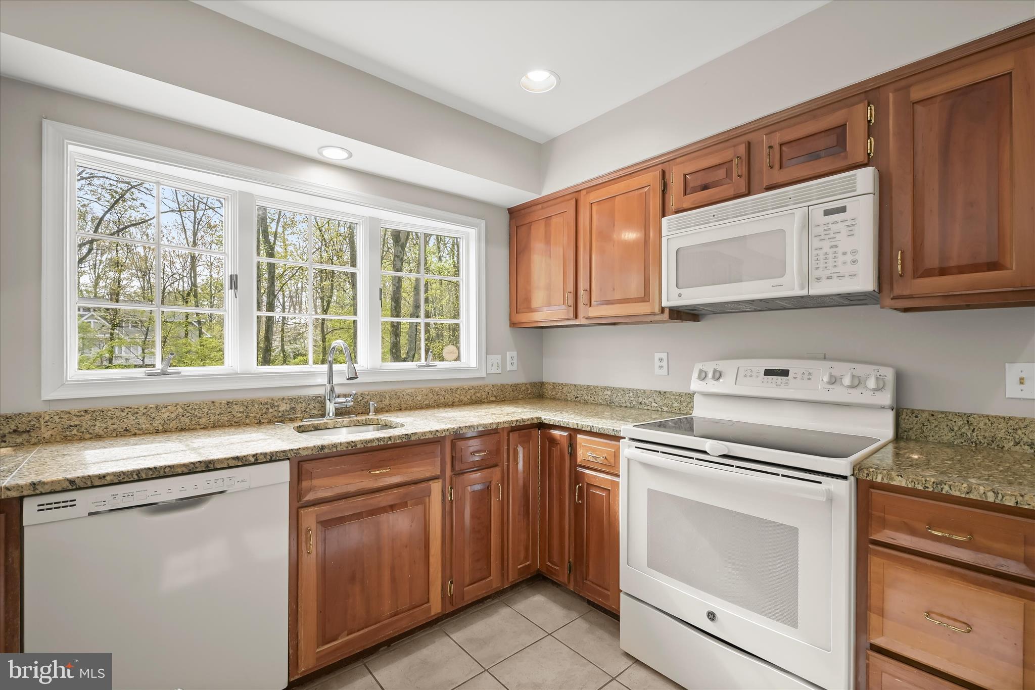 10428 Schoolmaster Place Columbia, MD 21044 - Photo 26 of 69 a kitchen with sink cabinets and window