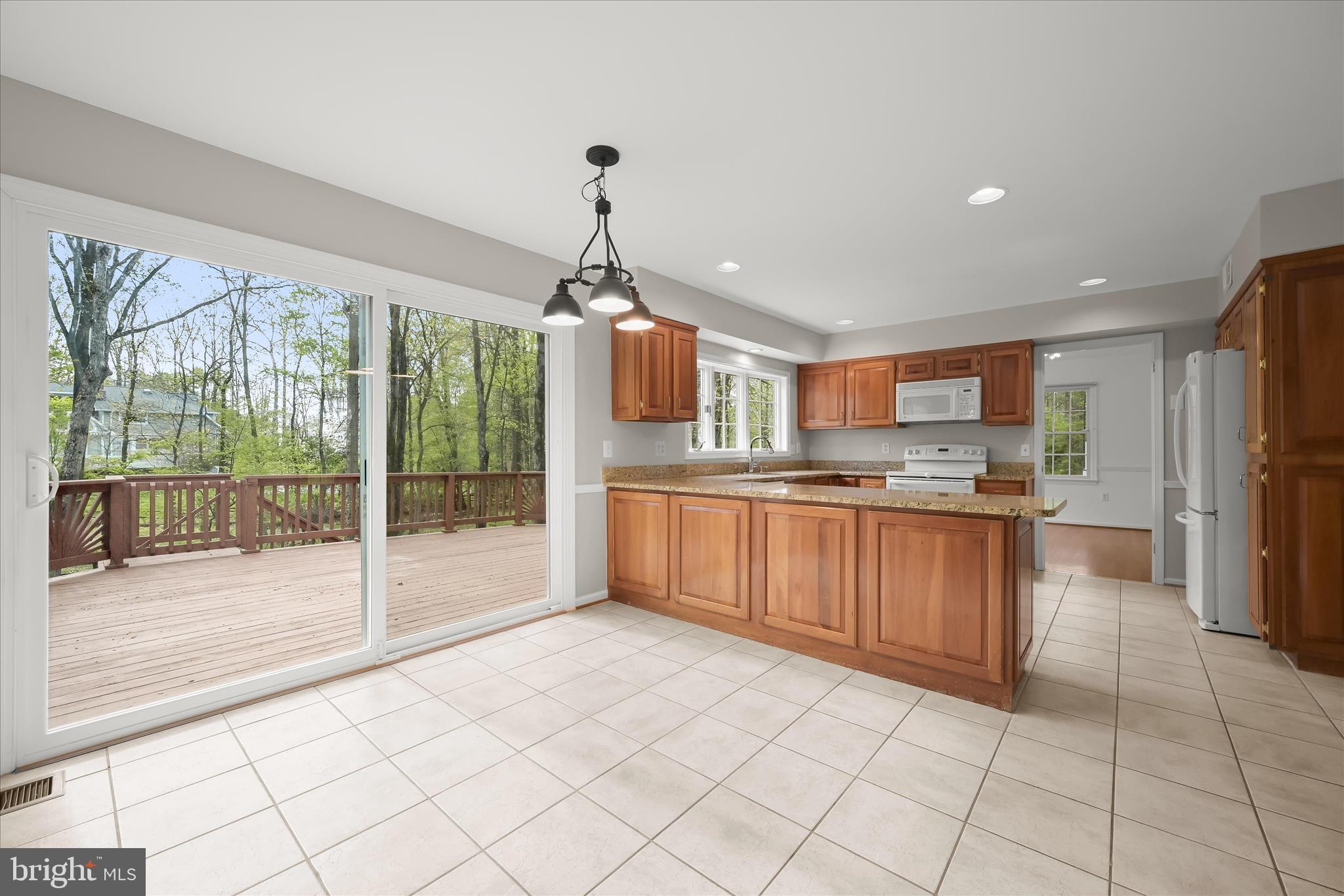 10428 Schoolmaster Place Columbia, MD 21044 - Photo 27 of 69 a large kitchen with kitchen island granite countertop a large counter top and stainless steel appliances