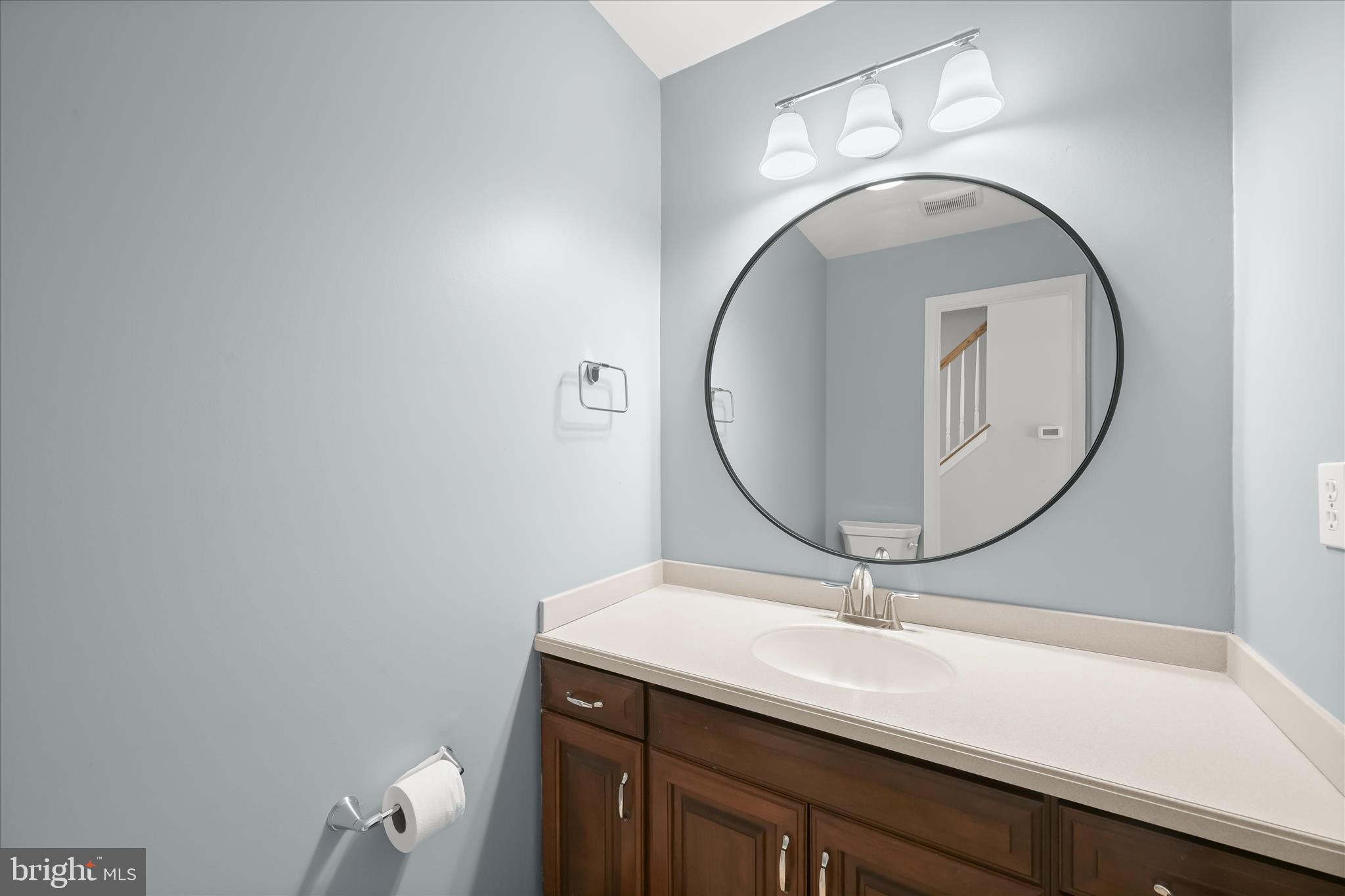 10428 Schoolmaster Place Columbia, MD 21044 - Photo 31 of 69 a bathroom with a sink and mirror