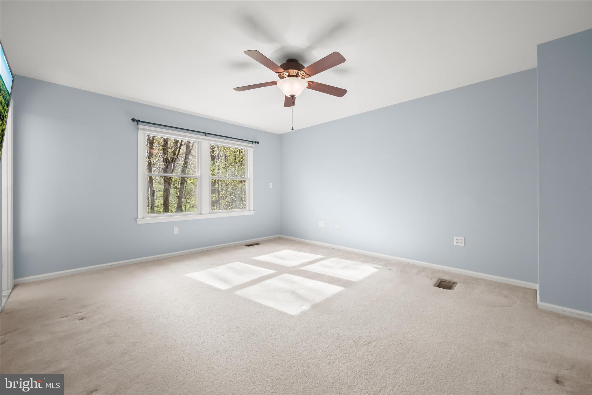 10428 Schoolmaster Place Columbia, MD 21044 - Photo 34 of 69 an empty room with windows and fan