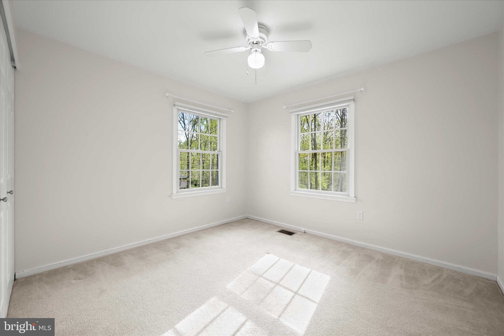 10428 Schoolmaster Place Columbia, MD 21044 - Photo 38 of 69 an empty room with windows and ceiling fan