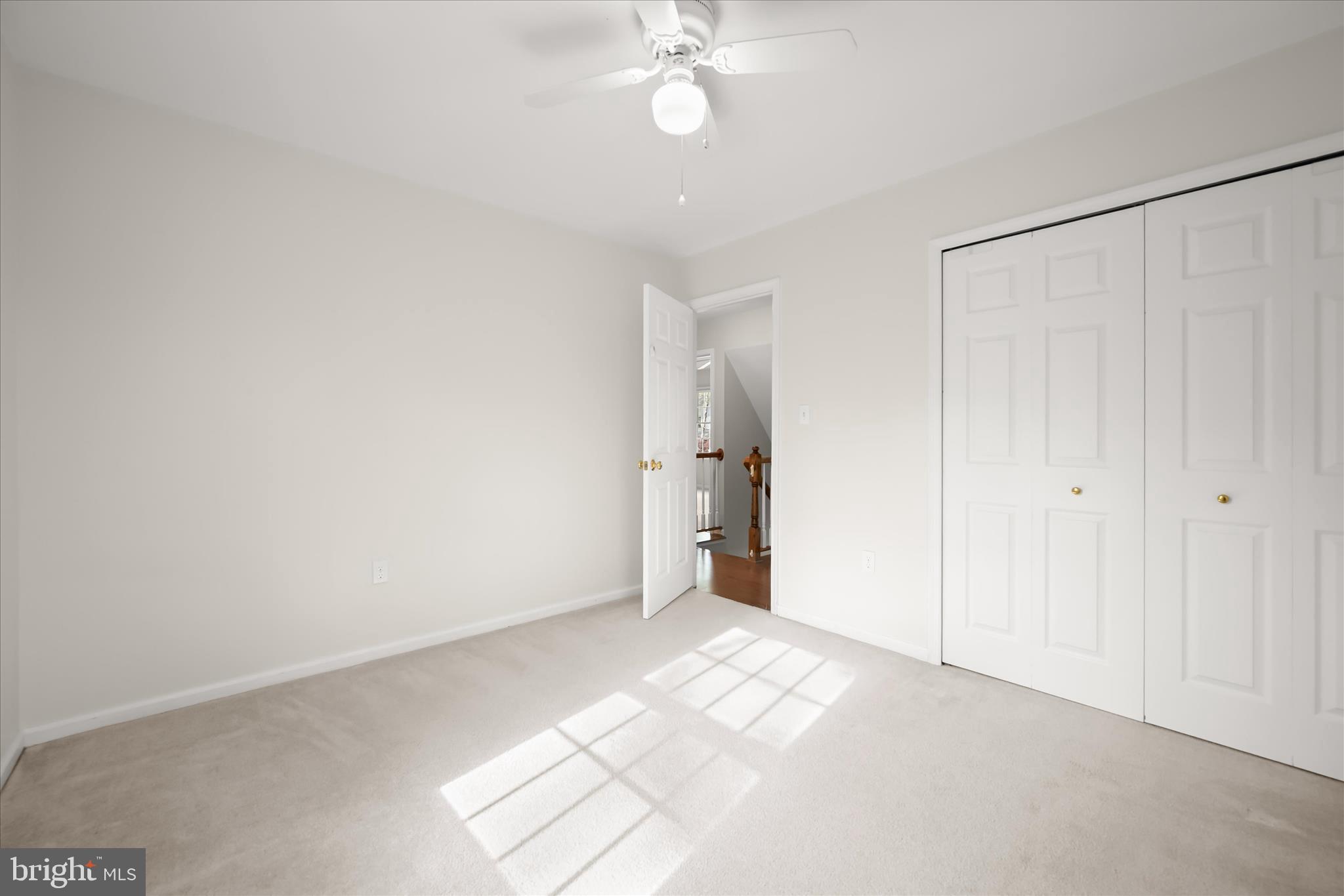 10428 Schoolmaster Place Columbia, MD 21044 - Photo 39 of 69 a view of an empty room with a ceiling fan