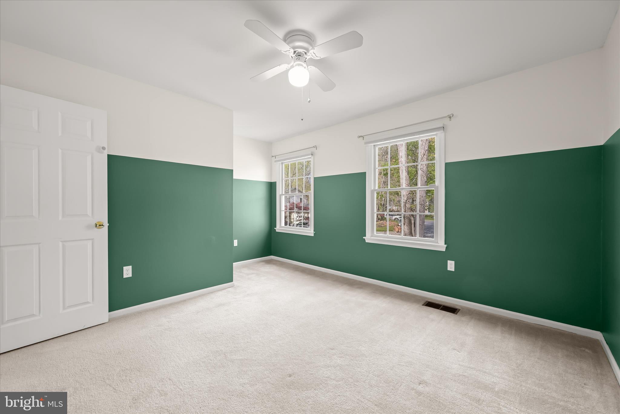 10428 Schoolmaster Place Columbia, MD 21044 - Photo 41 of 69 a view of an empty room with a window and a ceiling fan
