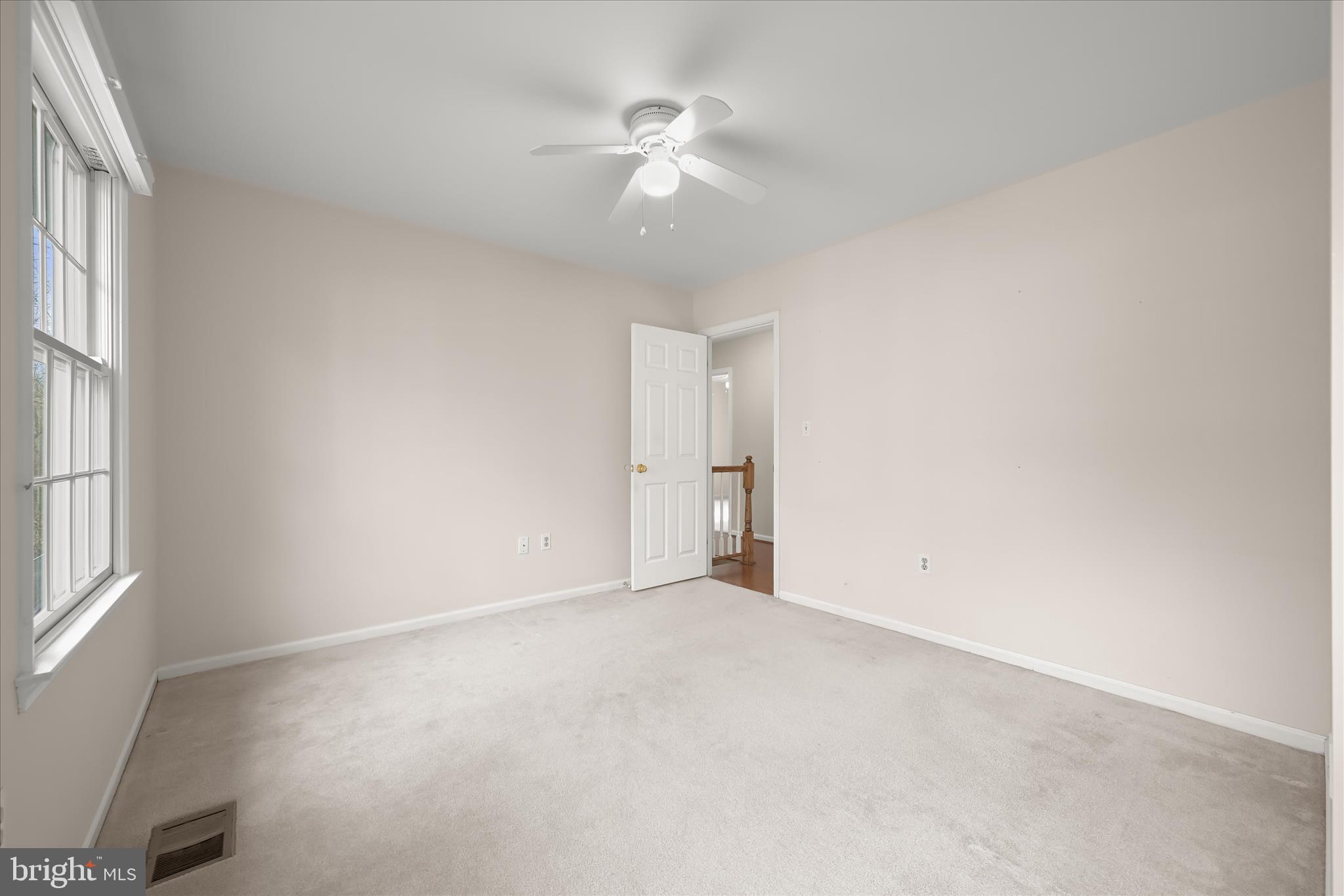10428 Schoolmaster Place Columbia, MD 21044 - Photo 44 of 69 an empty room with an entryway and a ceiling fan