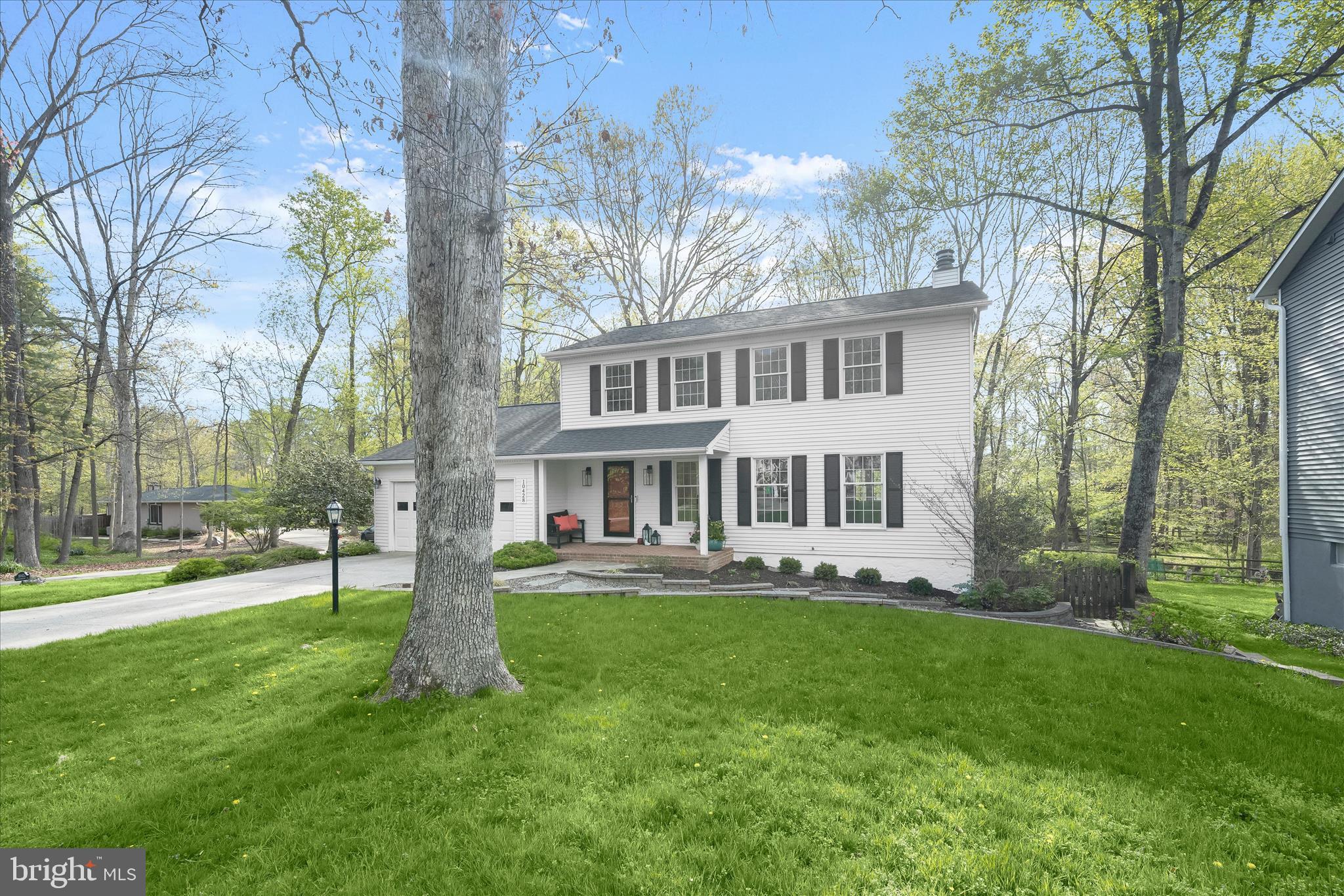 10428 Schoolmaster Place Columbia, MD 21044 - Photo 61 of 69 a front view of a house with a garden and trees