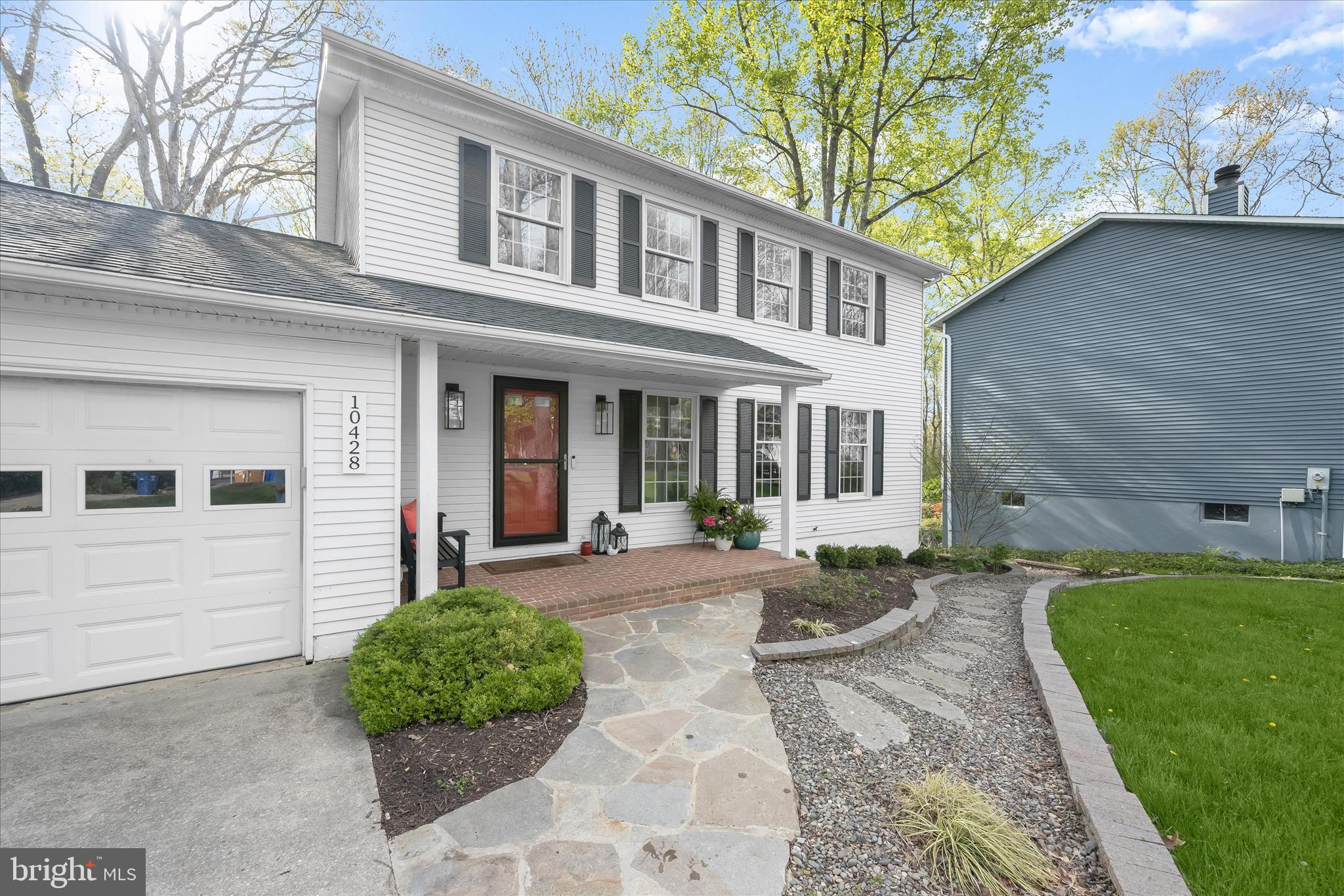 10428 Schoolmaster Place Columbia, MD 21044 - Photo 62 of 69 a front view of a house with garden and outdoor seating