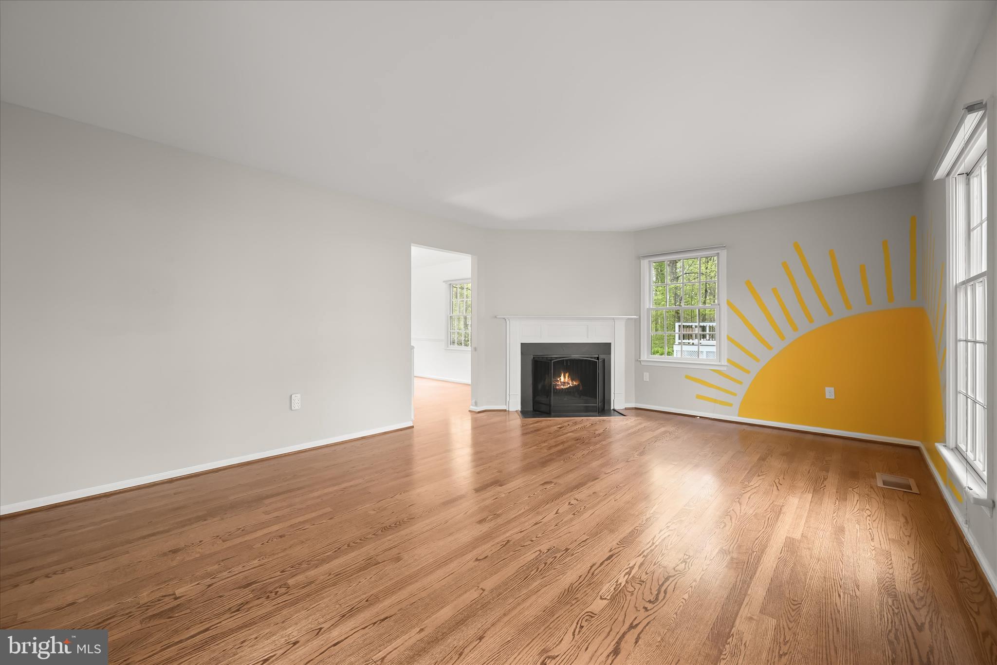 10428 Schoolmaster Place Columbia, MD 21044 - Photo 10 of 69 an empty room with wooden floor and fireplace