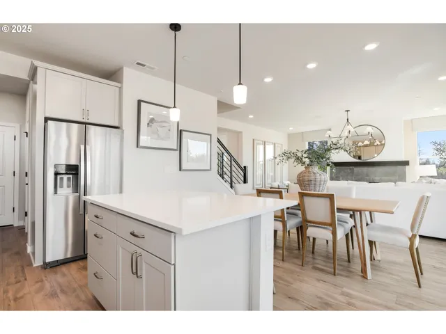 a kitchen with stainless steel appliances granite countertop a sink a stove and cabinets