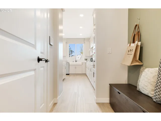 a living room with furniture a mirror and a large window