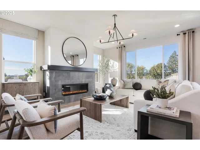 a living room with furniture kitchen view and a chandelier