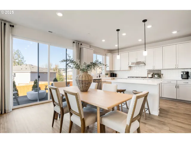 a dining room with furniture and wooden floor